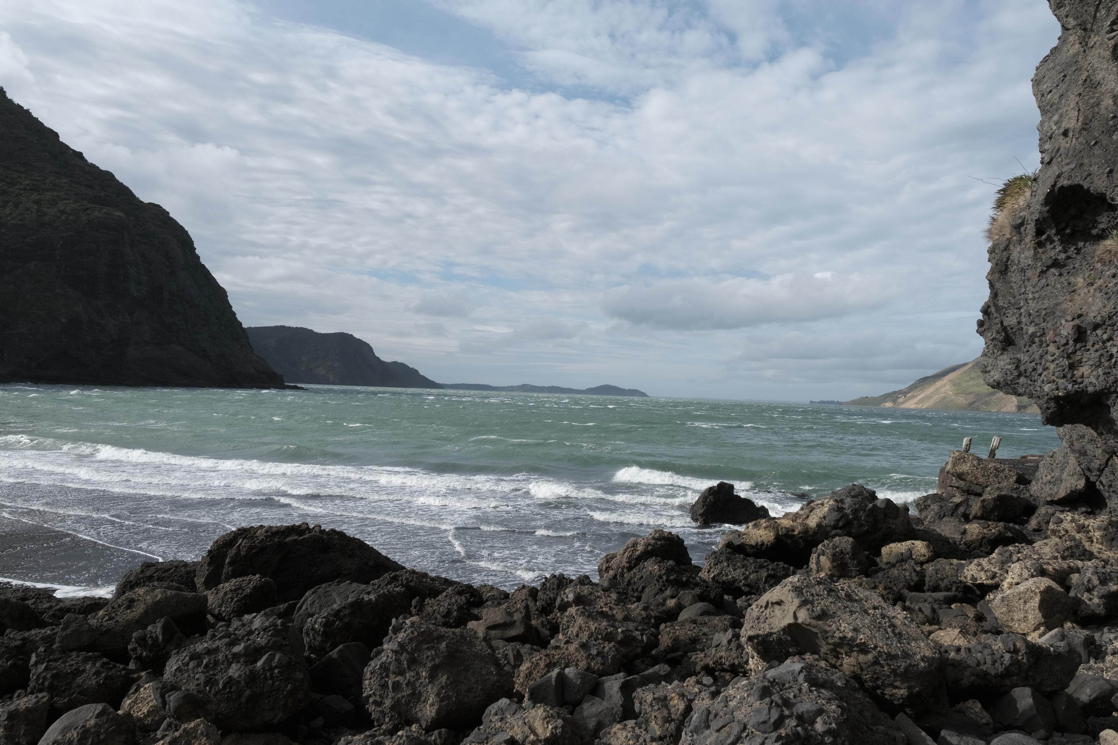 image of ocean with craggy rocks in the foreground
